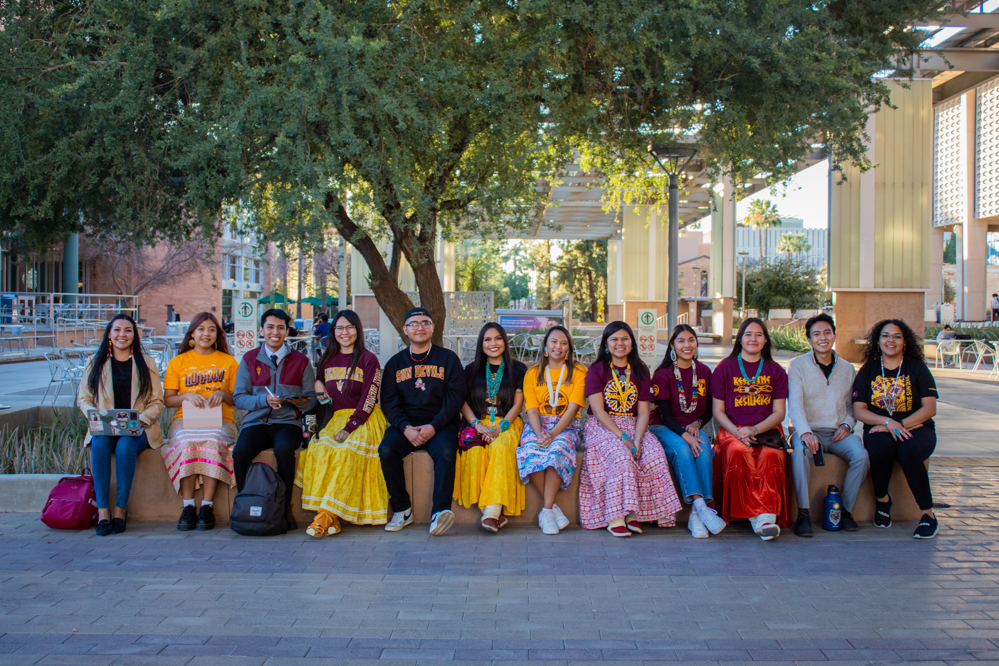 12 students sitting outside as a group on the ASU Tempe campus